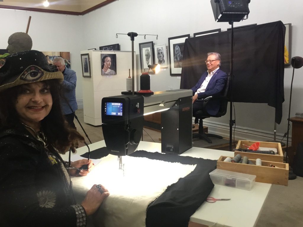 Cheryl Bridgart embroidering the portrait of His Excellency the Honourable Hieu Van Le AC